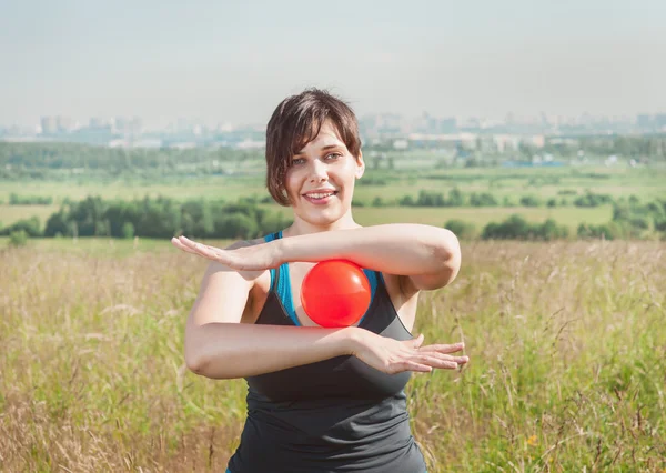 Beautiful woman exercising with ball