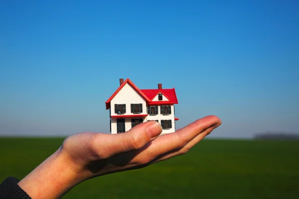 Hand holding model of residential building