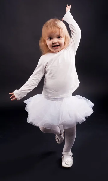 2 years old girl dancing in white
