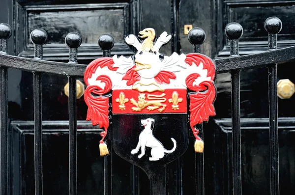 Detail of heraldic gate in front of door