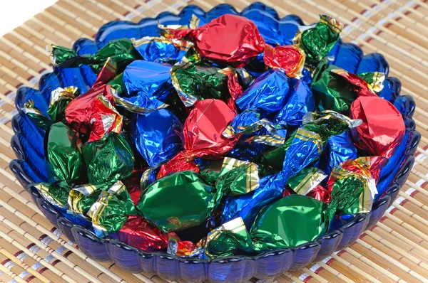 Chocolate candies in a glass blue dish