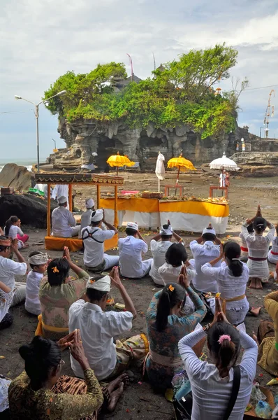 Praying at the Temple of Tanah Lot, Bali Indonesia
