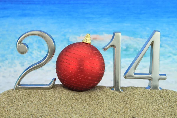 New year 2014 with Christmas ball on the beach — Stock Photo #22267387