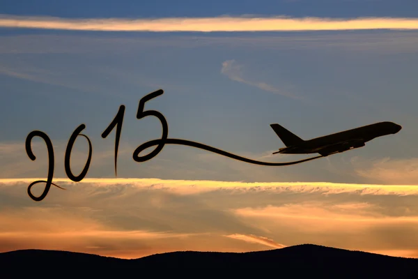New year 2015 drawing by airplane on the air at sunset