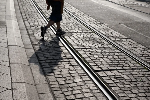 Person Walking across Tram Track — Stock Photo #13540149