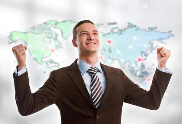 Portrait of young man standing in front of big world map.