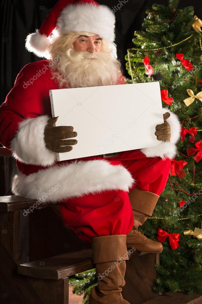 santa claus sitting indoors at dark room near christmas santa claus sitting indoors at dark room near christmas