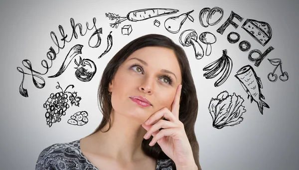 Young pretty woman thinking of healthy food closeup face portrait