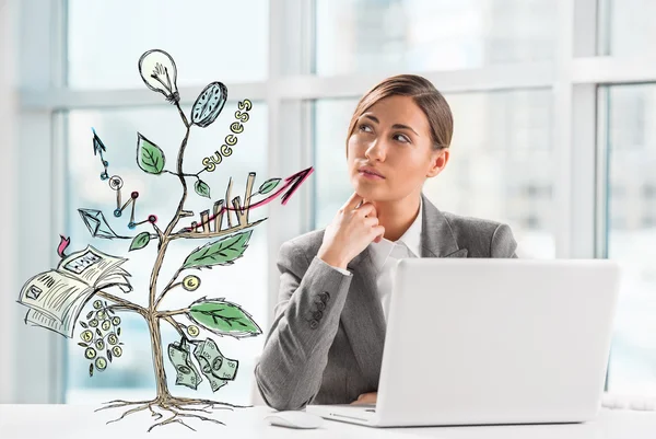 Concept of Growing company with sketch of a plant with business symbols and businesswoman working on laptop
