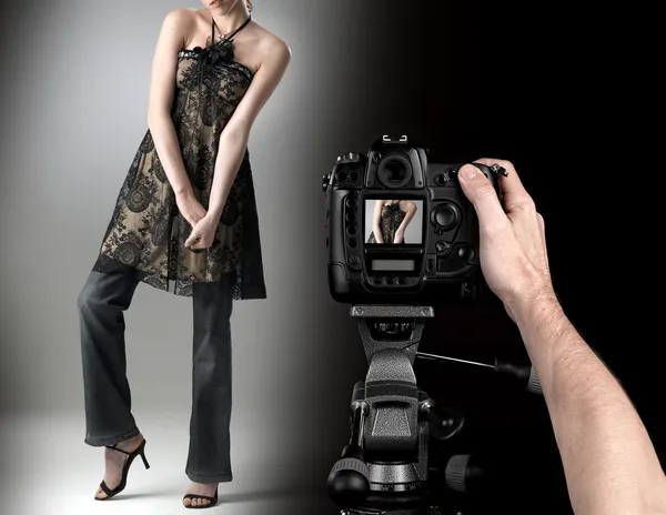 Professional photographer at studio fashion shot with a model.