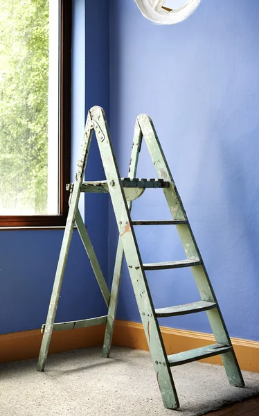 Home improvement with ladder and blue wall