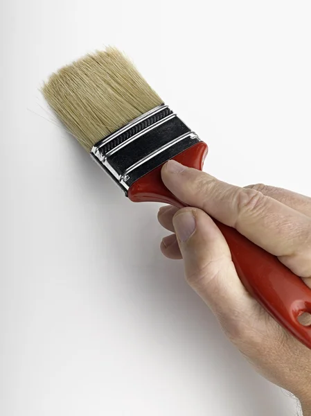 Man painting a wall with a brush