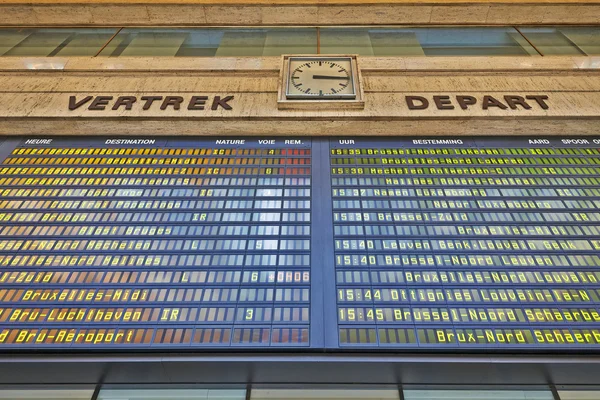 A schedule board in a train station with information