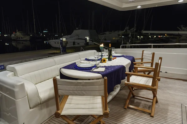 Stern deck and external dinner table on luxury yacht RIZZARDI TEKNEMA 65