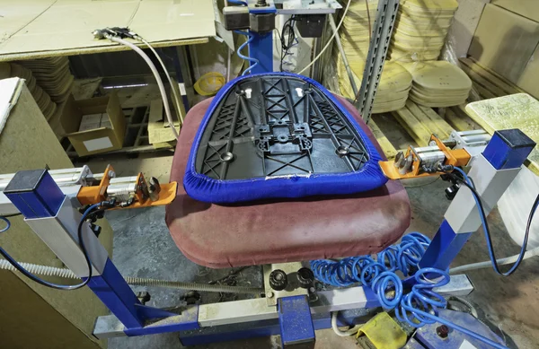 Office chair assembled with foam and cover in a foam rubber factory