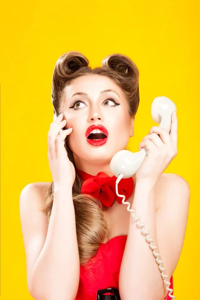 Pin-up girl talking on retro telephone