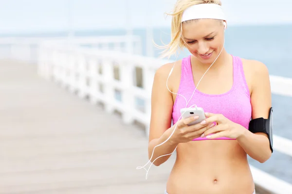 Young fit woman with phone