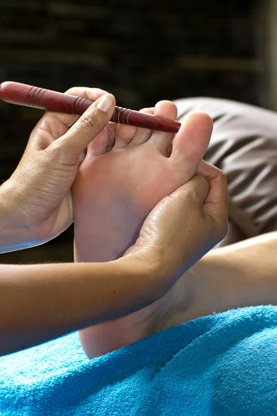 Reflexology foot massage, foot massage by wood stick for ear