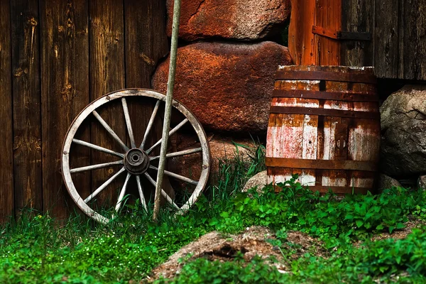 Still-life with an old wheel and barrel