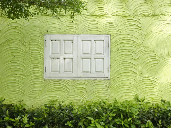The white window on the wave pattern wall.