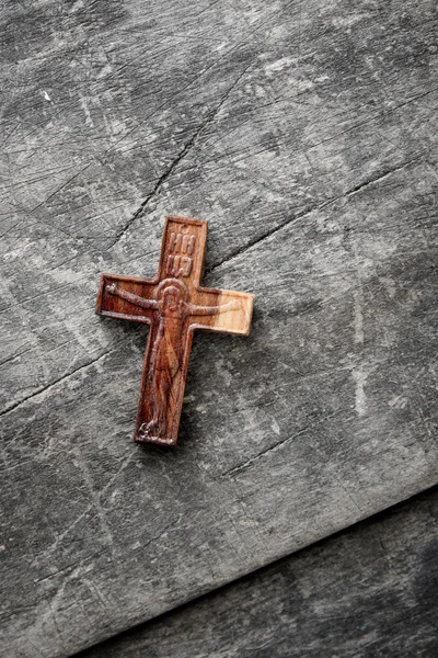 Wooden cross on a wooden background
