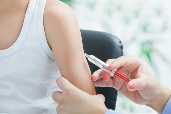 Doctor making vaccination to the patient