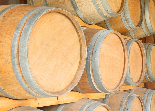 Round wooden wine barrels in cellar shelf.