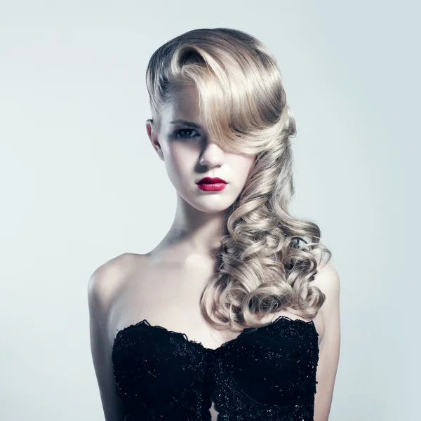 Beautiful blond woman with elegant black dress. Fashion photo