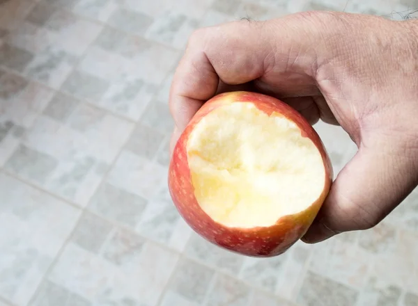 Man hand with bitten apple