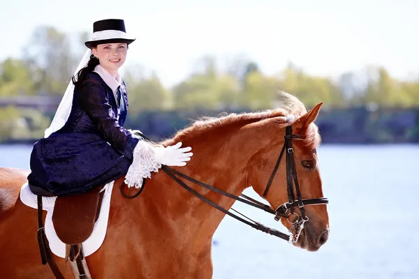 Portrait of the lady on a red horse.