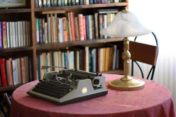 Typewriter and lamp on the desk in the library