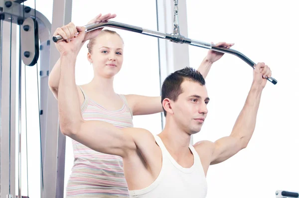 Gym man and woman doing exercise