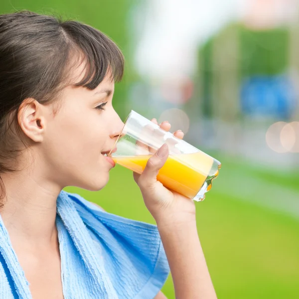 Girl drinking juice after exercise