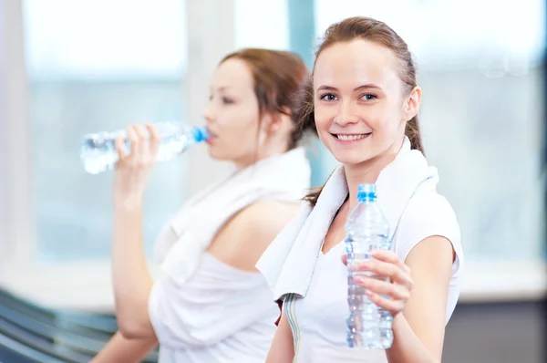 Women drinking water after sports