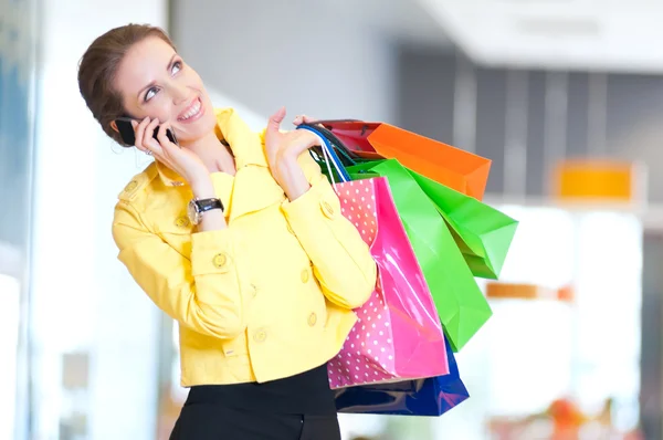 Shopping woman with phone and color bags — Stock Photo #37222729