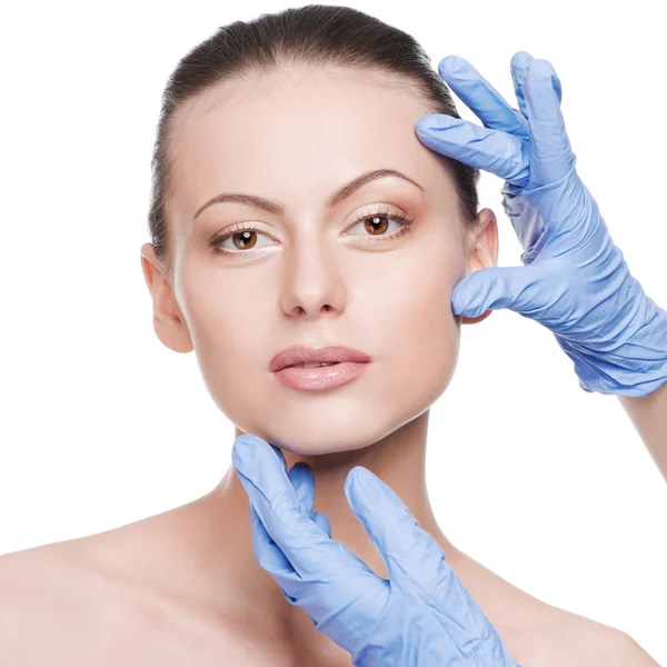 Beautician touch and exam health woman face