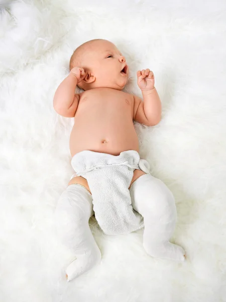Newborn baby boy with legs wrapped in bandage