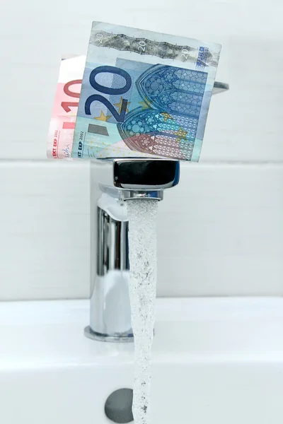 Euro money on the tap and flowing water