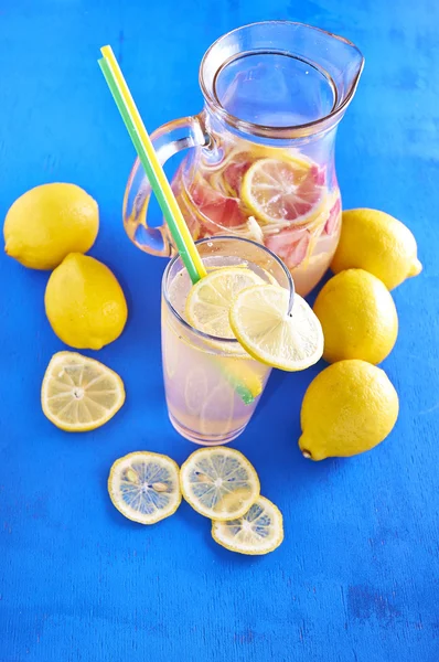 Pitcher of lemonade with lemons, and fresh