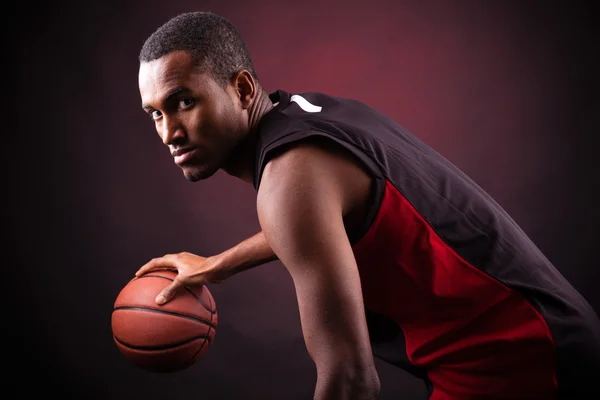 Portrait of a young male basketball player against black backgr — Stock Photo #15873929