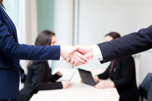 Business handshake at the office with bussiness