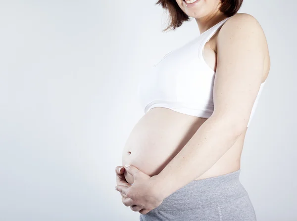 Pregnant woman touching her belly