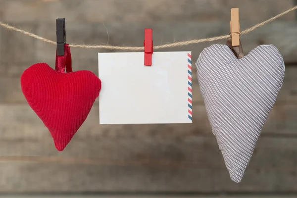 Blank instant paper shit and heart hanging on the clothesline