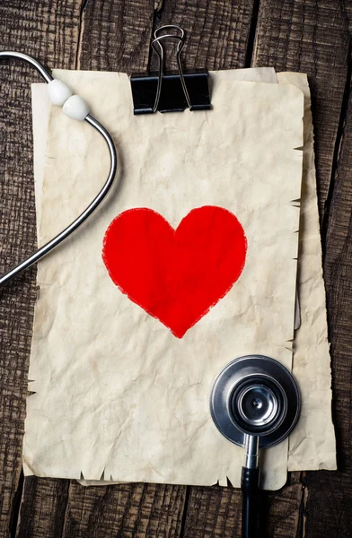 Wood texture background with stethoscope and heart symbol
