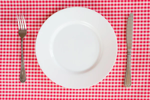 Fork Knife and Plate on a red table cloth