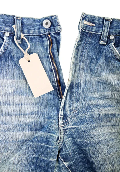 Unbuttoned blue jeans with paper label