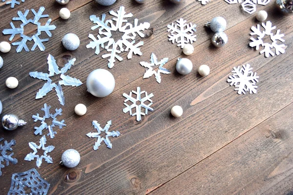 Paper cutout of snowflakes on wood background