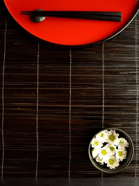 Chopsticks,flowers and Japanese red tray