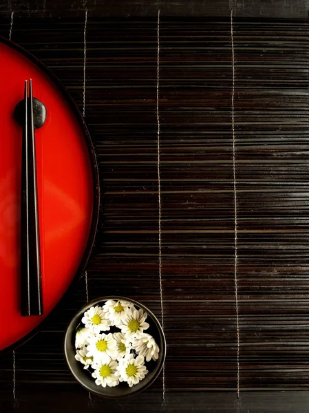 Chopsticks,flowers and Japanese red tray