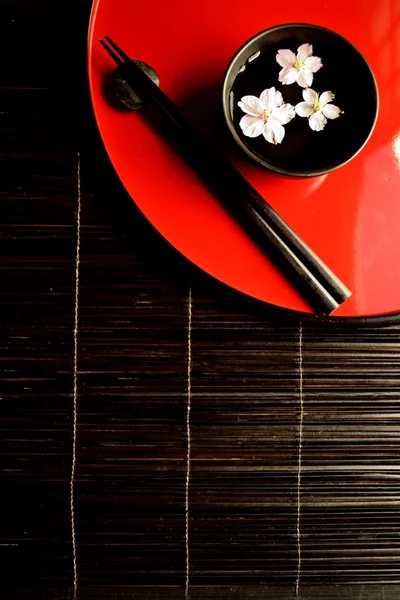 Japanese red tray,chopsticks and cherry blossoms